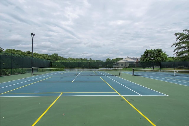 view of tennis court with fence