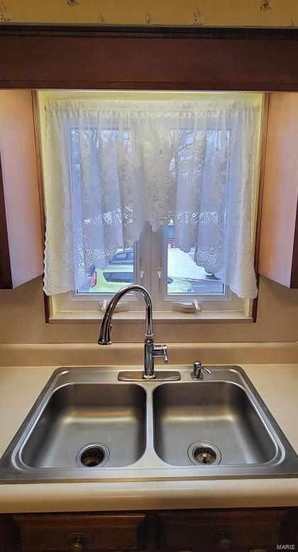 room details featuring light countertops and a sink