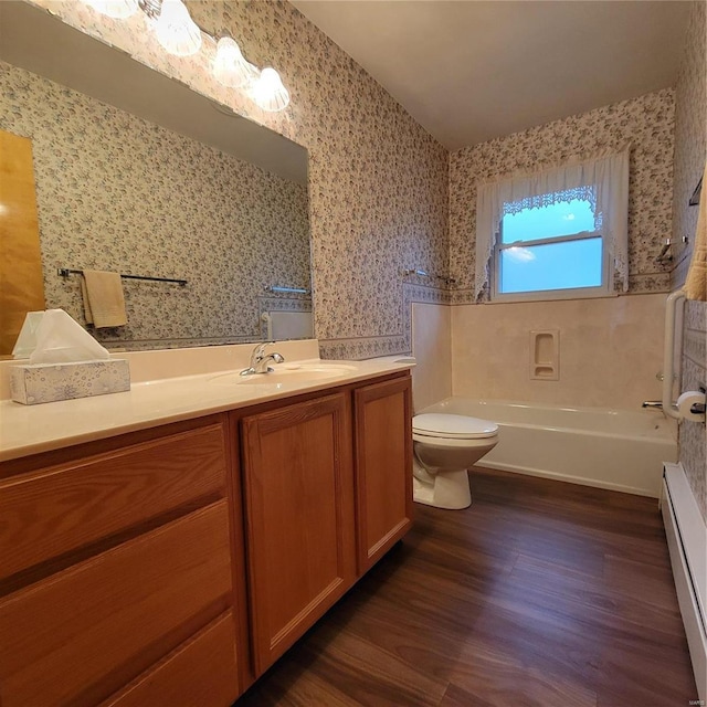 bathroom featuring wallpapered walls, toilet, baseboard heating, wood finished floors, and vanity