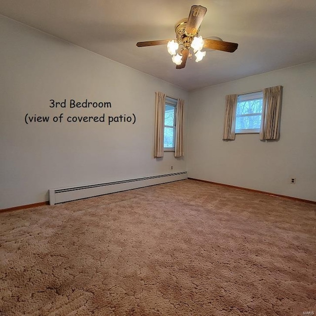 empty room with ceiling fan, baseboards, baseboard heating, and carpet floors