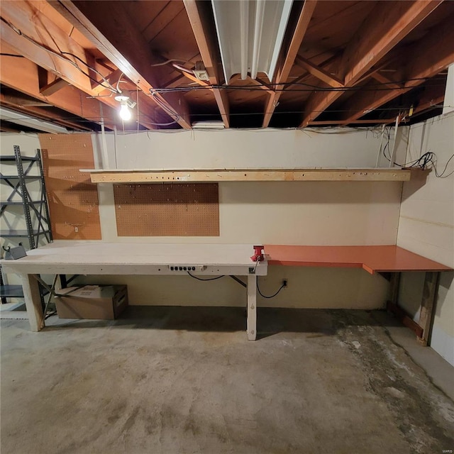 unfinished basement with a workshop area