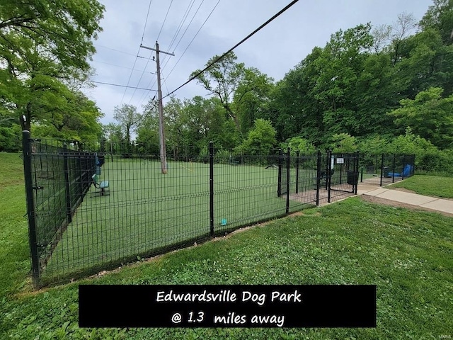 exterior space featuring a lawn and fence