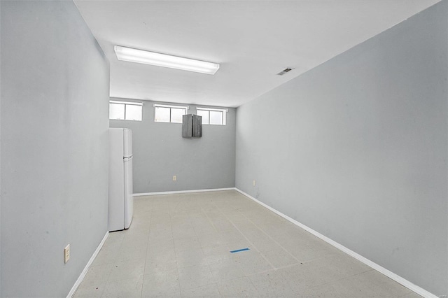 basement featuring white fridge