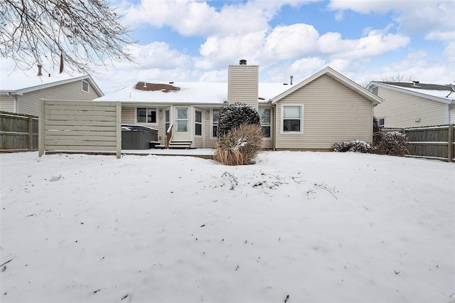 view of snow covered back of property