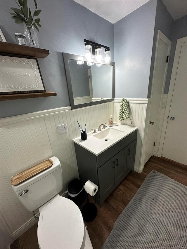 bathroom featuring vanity, toilet, and hardwood / wood-style floors