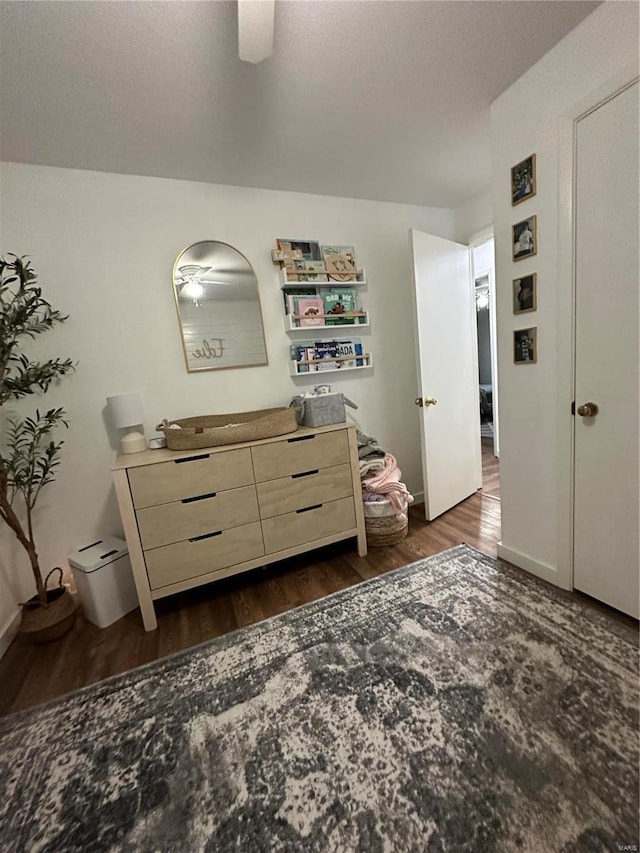 bedroom featuring ceiling fan and dark hardwood / wood-style floors