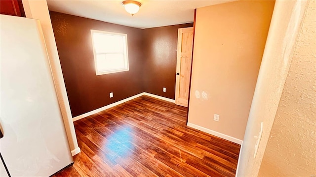 empty room with hardwood / wood-style floors