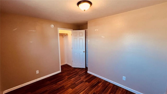 empty room with dark wood-type flooring