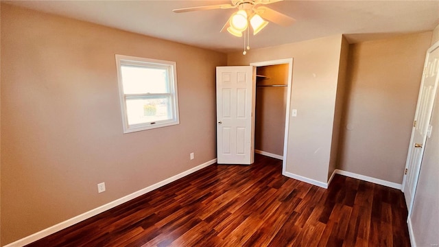 unfurnished bedroom featuring dark wood-type flooring, ceiling fan, and a closet