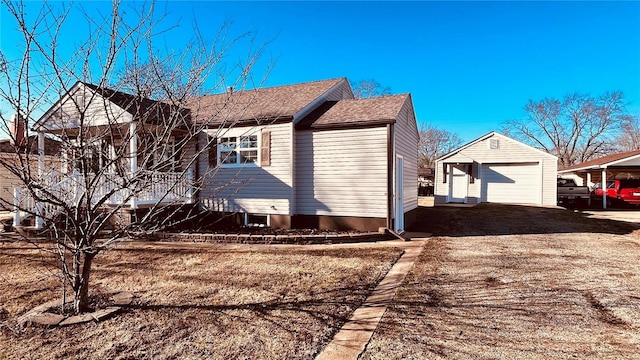 view of property exterior featuring a garage and an outbuilding