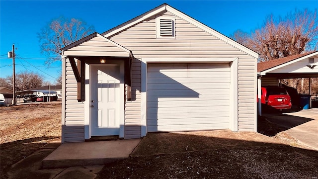 view of outdoor structure featuring a carport and a garage