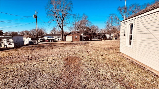 view of yard featuring a garage and an outdoor structure