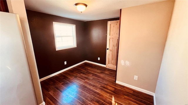 unfurnished room featuring dark hardwood / wood-style floors