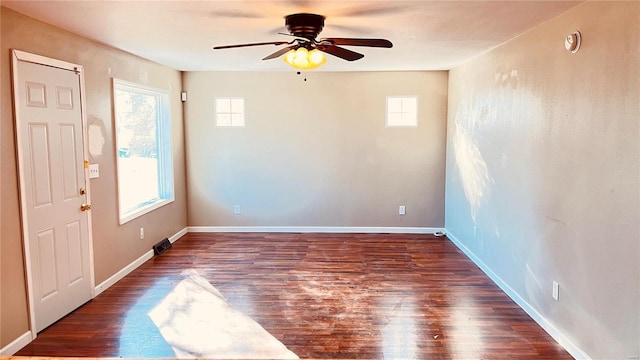 unfurnished room with ceiling fan and dark hardwood / wood-style flooring