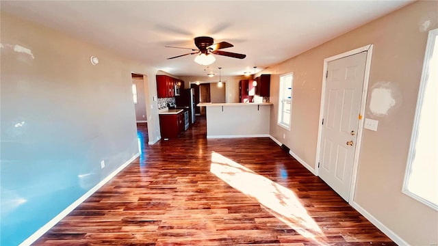 interior space featuring ceiling fan and dark hardwood / wood-style flooring