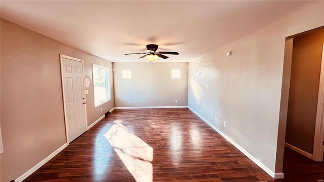 spare room featuring ceiling fan and dark hardwood / wood-style flooring