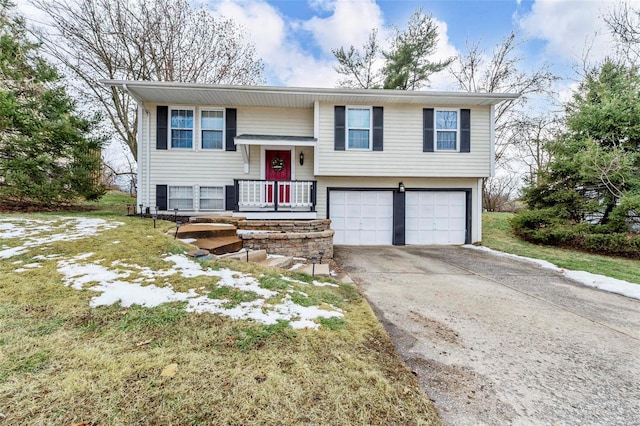 raised ranch featuring an attached garage and driveway