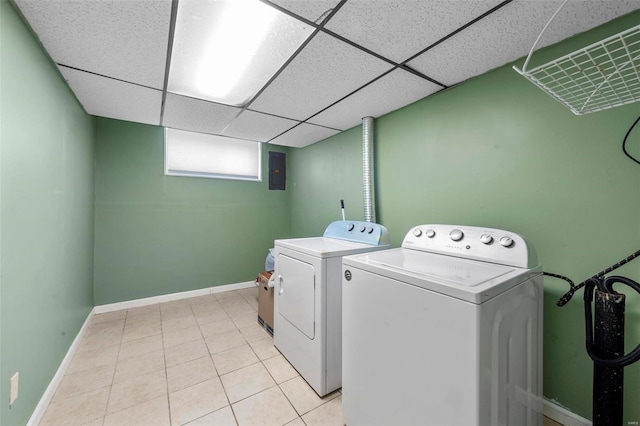 washroom with laundry area, independent washer and dryer, baseboards, and light tile patterned floors