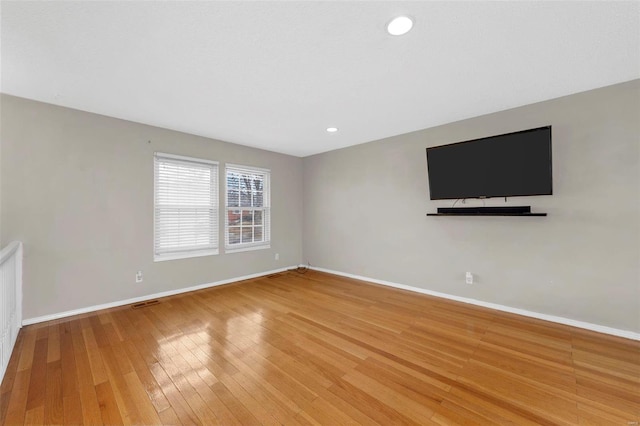 unfurnished living room featuring light wood-style floors, recessed lighting, visible vents, and baseboards