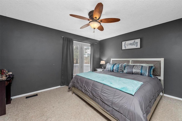 carpeted bedroom featuring visible vents, ceiling fan, a textured ceiling, access to outside, and baseboards