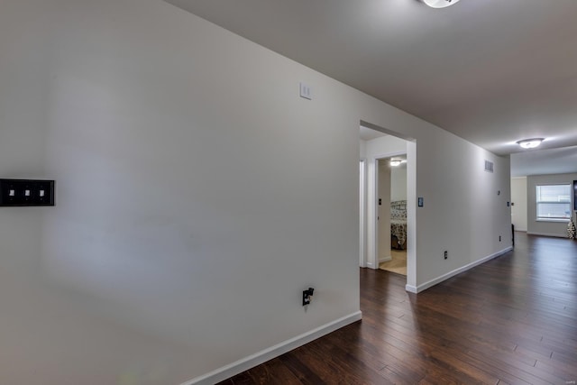 empty room featuring dark hardwood / wood-style flooring