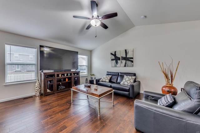 living room featuring vaulted ceiling, dark hardwood / wood-style floors, and ceiling fan