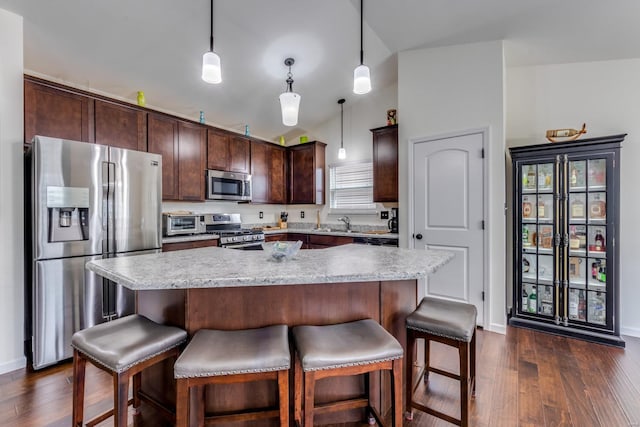 kitchen with pendant lighting, appliances with stainless steel finishes, and a kitchen island