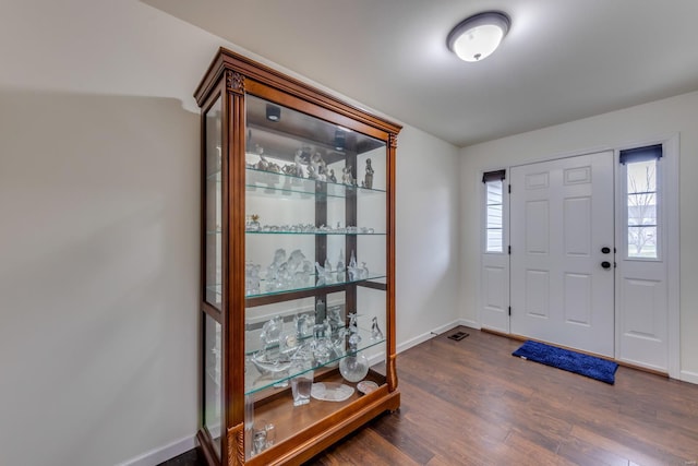 entryway with dark hardwood / wood-style floors