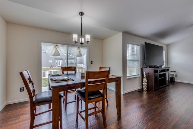 dining area featuring a notable chandelier and dark hardwood / wood-style flooring