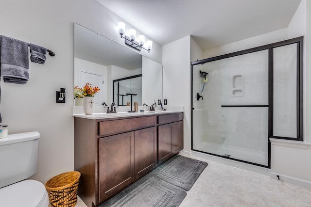 bathroom with vanity, an enclosed shower, and toilet