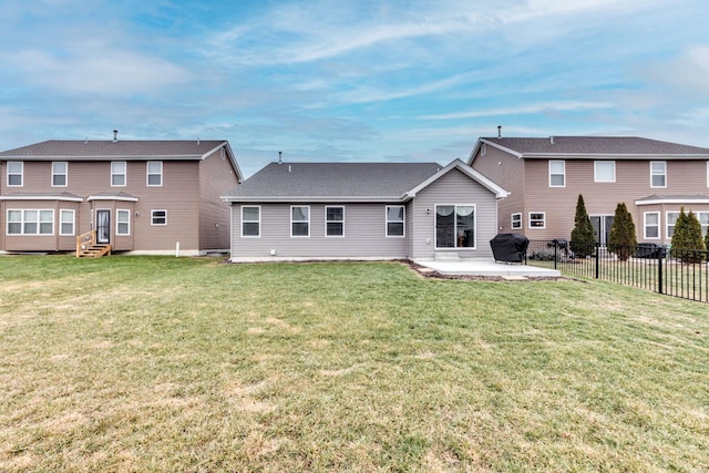 rear view of property featuring a lawn and a patio area