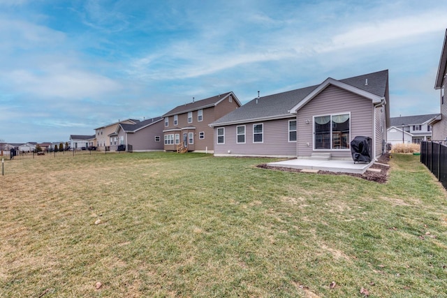 back of house featuring a yard and a patio