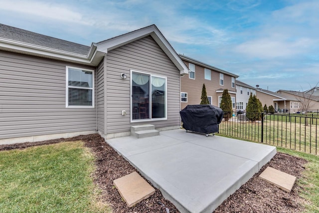 rear view of house with a lawn and a patio