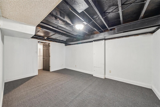 basement featuring dark colored carpet