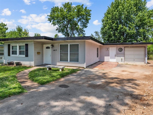 ranch-style home with a garage and concrete driveway