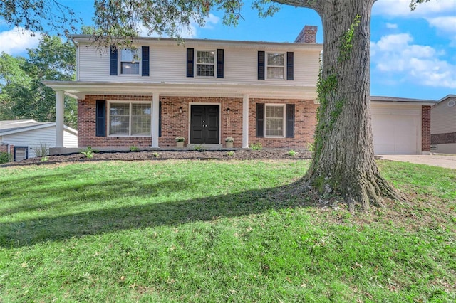 view of front of property featuring a garage, covered porch, and a front lawn