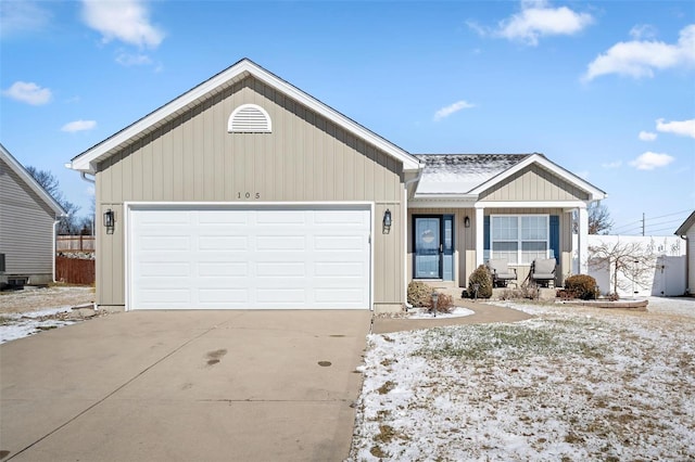 ranch-style house featuring a garage and driveway