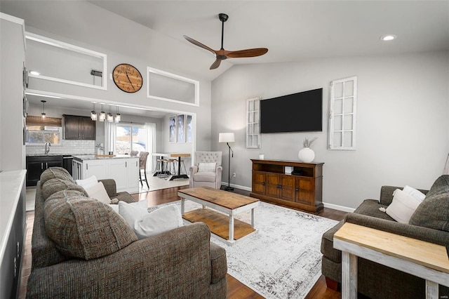 living room with dark wood-style flooring, baseboards, recessed lighting, a ceiling fan, and vaulted ceiling