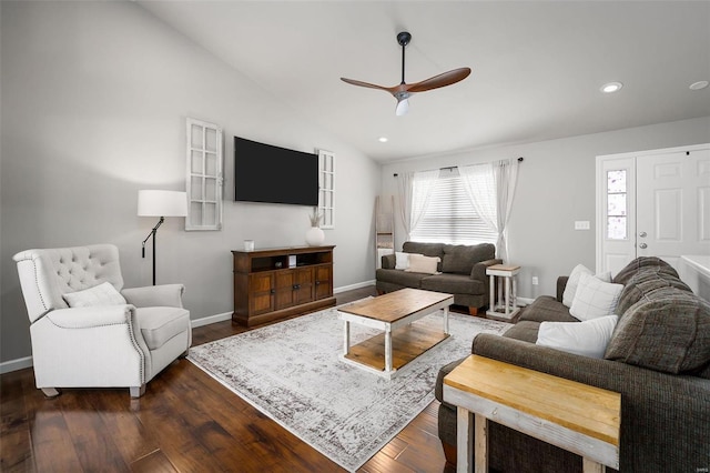 living area featuring baseboards, ceiling fan, vaulted ceiling, and dark wood finished floors