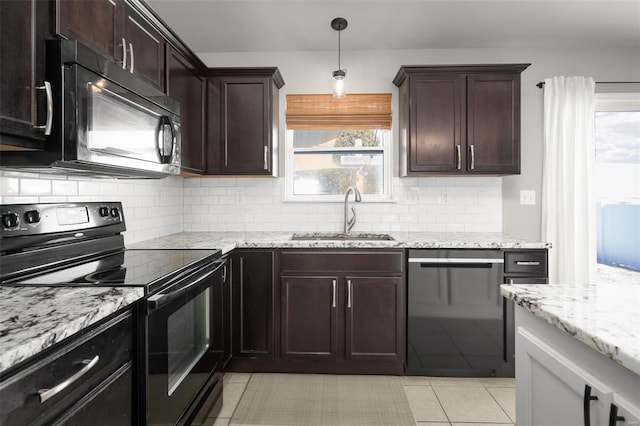 kitchen featuring light tile patterned floors, a sink, black appliances, and tasteful backsplash
