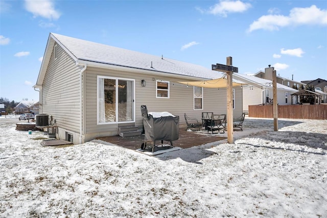back of house featuring entry steps, fence, and a patio