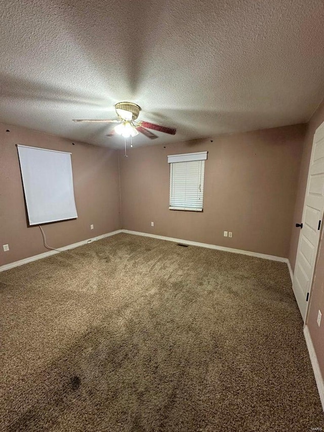 interior space featuring ceiling fan, a textured ceiling, and carpet flooring