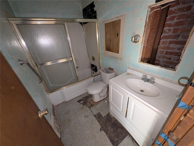 full bathroom featuring enclosed tub / shower combo, vanity, and toilet