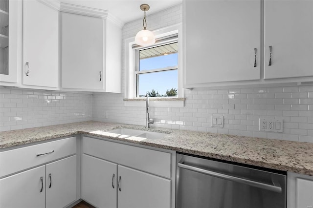 kitchen featuring white cabinetry, stainless steel dishwasher, sink, and backsplash