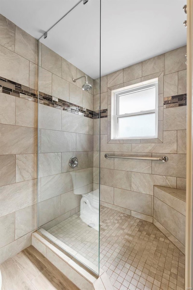 bathroom with tiled shower