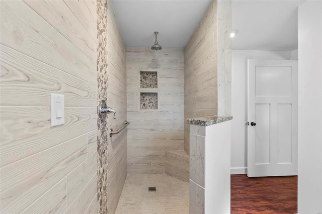 bathroom featuring hardwood / wood-style flooring and tiled shower