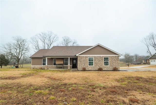 ranch-style house with covered porch and a front lawn