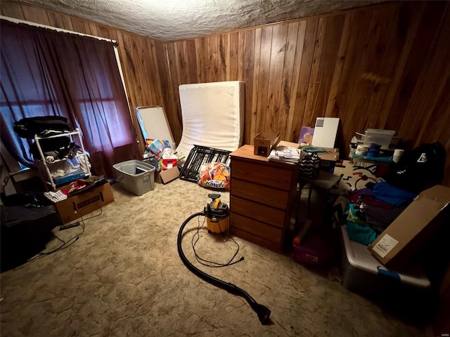 carpeted office with a textured ceiling and wood walls