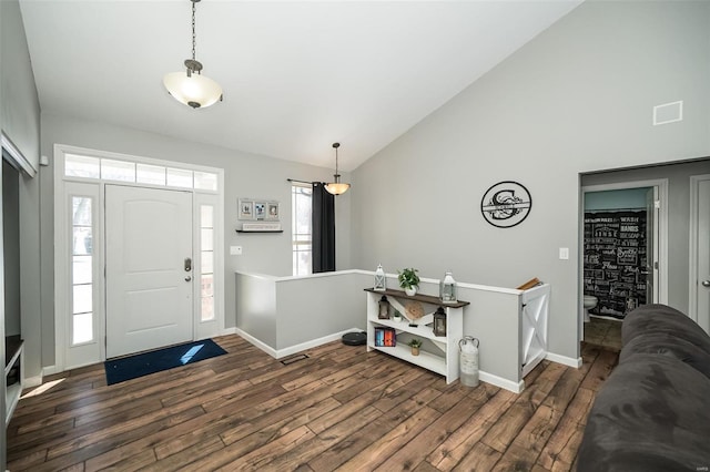 foyer featuring high vaulted ceiling, dark wood finished floors, and baseboards