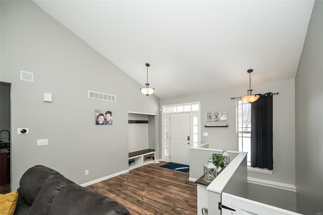 entryway featuring high vaulted ceiling, wood finished floors, visible vents, and baseboards